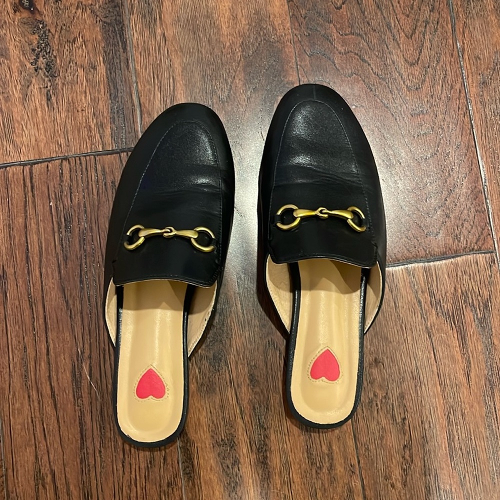 Black loafers with gold detail